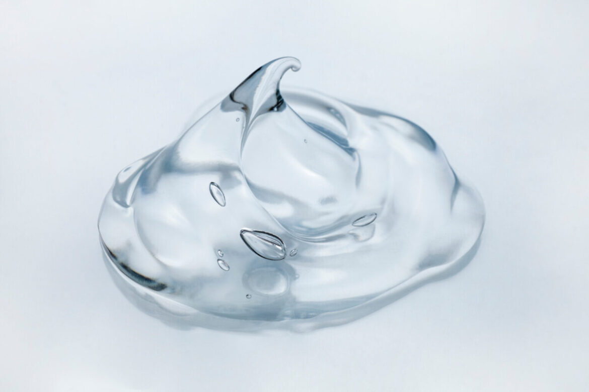 A transulcent pile of viscous goo (a silicone polymer) on a blank background